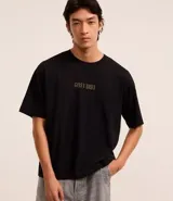 Remera negra de algodón, corte boxy, con cuello redondo y mangas cortas. Estampa frontal con el logo de Guns N' Roses en color dorado.