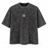 Remera oversize color negro con efecto lavado acid wash, de manga corta, con diseño gráfico estampado en el pecho y la espalda de la marca La Ola.