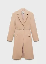 Abrigo largo de diseño oversize en color beige, confeccionado en tejido mezcla de lana. Presenta cuello con solapas, hombros estructurados y pronunciados, manga larga y dos bolsillos laterales con solapa. Incluye un cinturón fino ajustable en la cintura y abertura posterior en el bajo.