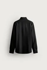 Camisa regular fit de manga larga con diseño de rayas verticales celestes y blancas, cuello italiano y cierre frontal con botones.