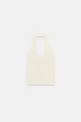 Top color crema de tejido de punto con cuello halter y escote redondo.