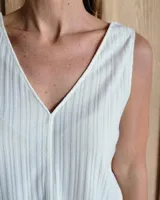 Musculosa color crudo con escote en V y textura acanalada vertical.