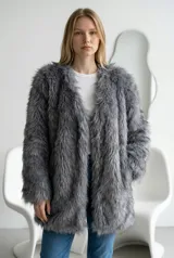 Abrigo de piel sintética gris, de corte recto y largo medio, con diseño abierto sin botones y mangas largas.