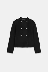 Chaqueta de corte recto confeccionada en mezcla de lana, con cuello redondo y manga larga. Presenta un diseño cruzado con botones metálicos plateados y acabados deshilachados en cuello, puños y ruedo.