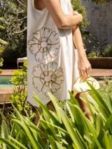 Vestido corto gris con bordado de flores en el frente.