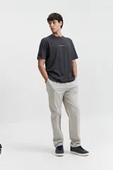 Remera de manga corta color gris oscuro, con estampado frontal de la palabra "Unlimited" en blanco y un pequeño detalle de etiqueta en la manga izquierda.