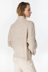 Campera de punto a rayas horizontales en tonos amarillo pastel y lila, con cuello alto, cierre frontal completo y mangas largas con bordado distintivo en la manga.