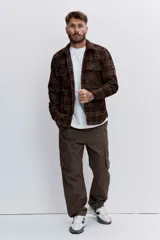 Pantalon cargo de corte holgado en color marrón, con bolsillos laterales con solapa y cierre frontal.