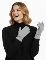 Guantes de tejido soft color gris claro, con un pequeño lazo decorativo en la parte superior de la muñeca.