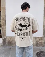 Remera de corte oversize color beige stone wash, con estampa gráfica en la espalda que incluye un auto estilo caricatura y tipografía gótica con la frase 'Baja expectativa, alta fidelidad'.