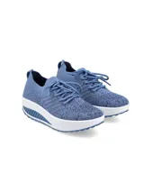 Zapatillas Hush Puppies modelo Amaze, de diseño slip-on con cordones decorativos. Confeccionadas en tejido flyknit color azul denim, cuentan con una suela de plataforma blanca con diseño estriado y plantilla de memory foam para mayor amortiguación.
