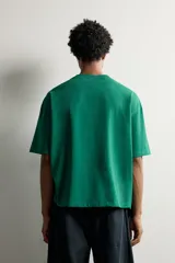 Remera relaxed fit color verde con efecto lavado, cuello redondo y manga corta.