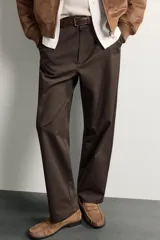 Pantalón chino de corte regular, color marrón oscuro, con cierre frontal de cremallera y botón, bolsillos laterales y bolsillos traseros de vivo.