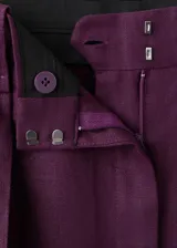Bermudas de lino color bordó con diseño recto, tiro bajo, pinzas y bolsillos laterales.