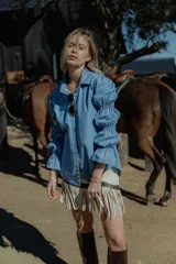 Camisa celeste de jean fino, de corte clásico y mangas largas con puños abullonados.