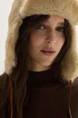 Polera de tejido de punto color azul, con cuello alto, manga larga y puños acanalados.