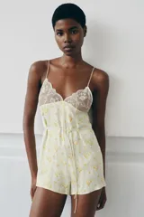 Mono corto de viscosa con estampado floral amarillo sobre fondo verde menta, escote cuadrado con detalles de encaje y tirantes finos.