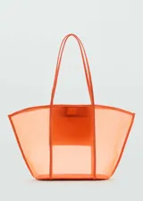 Bolso tipo shopper de diseño semitransparente en color naranja, con doble asa larga y cierre de botón magnético. Incluye un bolsillo interior.