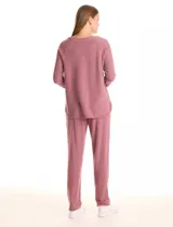 Buzo rosa de tejido suave, con cuello redondo y ribete, escote en V, mangas largas tipo raglán y corte holgado.