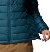Chaqueta acolchada de mujer con capucha, color azul petróleo, con cierre frontal, bolsillos laterales con cremallera y tecnología de aislamiento térmico.
