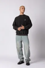 Buzo de cuello redondo con calce oversize y efecto lavado (washed). Presenta una estampa gráfica en la espalda con el diseño de una copa de martini y texto descriptivo.