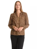 Blusa de gasa con estampado animal print, cuello a la base con escote en V y cierre frontal, manga larga con puños elastizados.