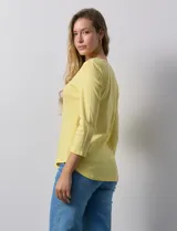 Remera de algodón negra, de corte clásico, con mangas tres cuartos y cuello redondo.