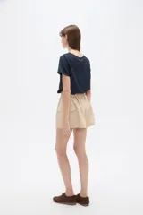 Short cargo negro de poliéster, con cintura elástica fruncida y cordón ajustable. Posee bolsillos laterales tipo cargo.