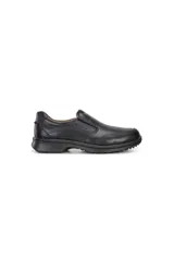 Zapato tipo mocasín slip-on de cuero negro, con costuras decorativas en la parte superior y suela de poliuretano gruesa y texturizada.