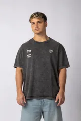Remera de algodón con efecto lavado ácido en color gris, de corte holgado y manga corta. Presenta estampados gráficos minimalistas en el pecho y cuello redondo acanalado.
