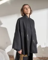 Capa negra de paño de lana con cuello mao y cierre frontal con ganchos ocultos. Estampado serigráfico negro brillante en cuerpo y cuello.