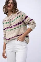 Sweater de lana merino con estampado Fair Isle en tonos azul marino, beige, naranja, verde oliva y bordó. Tiene cuello redondo y mangas largas.