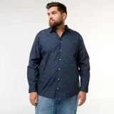 Camisa de corte recto y manga larga en color azul marino, con estampado de pequeños motivos blancos. Presenta cuello clásico y cierre frontal con botones.