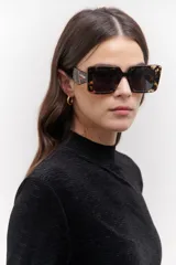 Lentes de sol cuadrados con montura gruesa de carey y lentes grises.