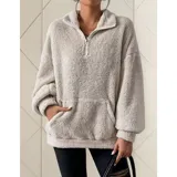 Buzo de polar con textura suave, color beige, con cuello alto y cierre frontal parcial. Diseño de manga larga y calce holgado.