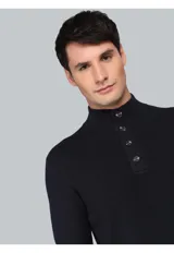 Sweater de punto color azul marino, con cuello alto y cierre frontal parcial de botones. Presenta puños y ruedo acanalados.