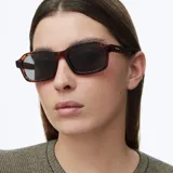 Lentes de sol con montura cuadrada de carey y lentes oscuras polarizadas con protección UV.
