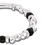 Pulsera elástica con cuentas de aleación de metales bañadas en plata y cristal de murano negro.