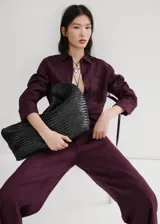 Pantalon de lino color bordo, de corte recto y tiro medio, con cintura elastizada y bolsillos laterales.