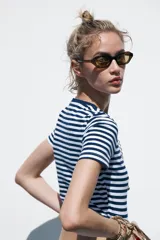 Camiseta cropped color amarillo, de corte slim fit, cuello redondo y manga corta.