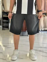 Bermuda de jean de corte baggy y tiro medio, con diseño clásico de cinco bolsillos y lavado claro.