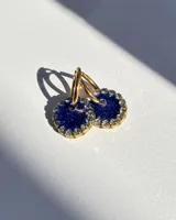 Aros de acero quirúrgico con dije circular de resina rosa y borde de strass dorados.