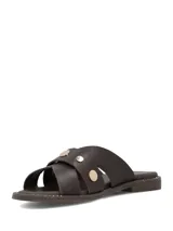 Sandalia plana color marrón oscuro, confeccionada en cuero, con tiras cruzadas en el empeine y tachas metálicas doradas decorativas.