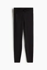 Leggings deportivos negros de tiro alto, confeccionados en tejido funcional SoftMove™ con tecnología DryMove™ para absorción del sudor. Presentan cintura ancha con un delicado diseño cruzado o fruncido en la parte frontal y ajuste ceñido al cuerpo.