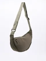 Morral tipo riñonera o bandolera de color negro, con cuerpo acolchado y correa ajustable de tela verde militar.