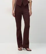 Pantalón de corte flare confeccionado en tejido Punto Roma, con diseño de tiro alto, recortes verticales a lo largo de las piernas y cintura elástica sin cierre.