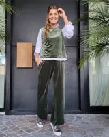 Pantalón de corte amplio y tiro medio, confeccionado en terciopelo color beige. Presenta cintura elástica con cordón ajustable y bolsillos laterales.