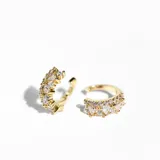 Par de aros ear cuff dorados con cristales blancos.