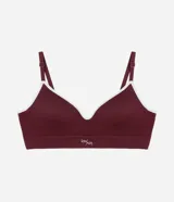 Soutien tipo bralette de color blanco hueso, sin costuras (seamless), con copas moldeadas y escote en V. Presenta una banda ancha elástica bajo el busto para mayor soporte y tirantes finos ajustables.