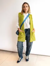 Chaleco largo de piel sintética color blanco, con cuello solapa y dos bolsillos delanteros.